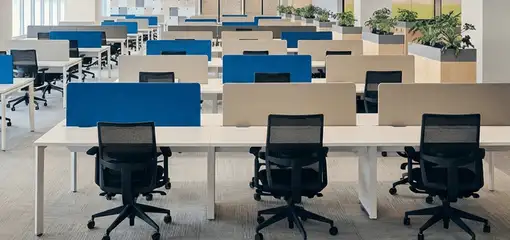 Modern open-plan office space featuring clean workstations, ergonomic chairs, and sanitized carpets provided by professional office cleaning services in Bradenton, FL.