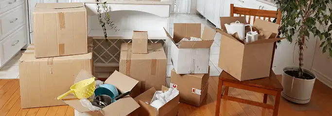 Packed moving boxes and household items in a kitchen before move-out or move-in cleaning, Bradenton, FL.